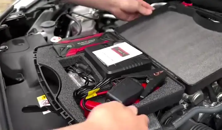 Open carry case with the jump starter, clamps and charger inside